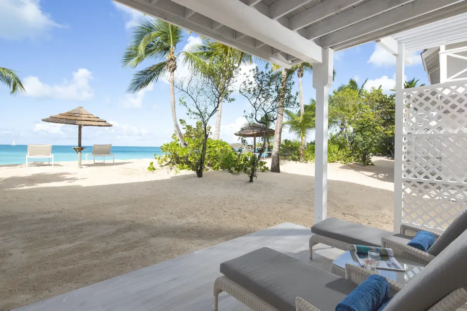 Deluxe Beachfront patio loungers facing the beach at Galley Bay Resort & Spa.