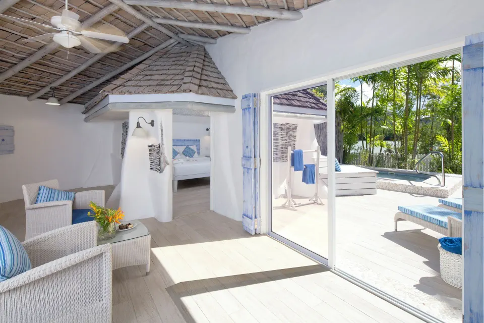 Gauguin Suite living area opening to a pool deck at Galley Bay Resort & Spa.