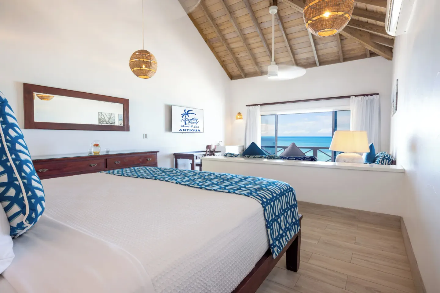 Premium Beachfront Suite king bed with ocean-facing window at Galley Bay Resort & Spa.