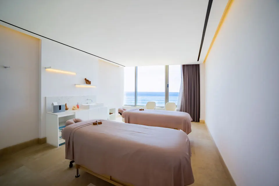 Two spa treatment beds facing ocean-view windows at Garza Blanca Los Cabos.