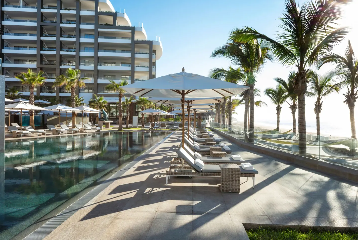 Rows of loungers and umbrellas beside the pool at Garza Blanca Los Cabos.