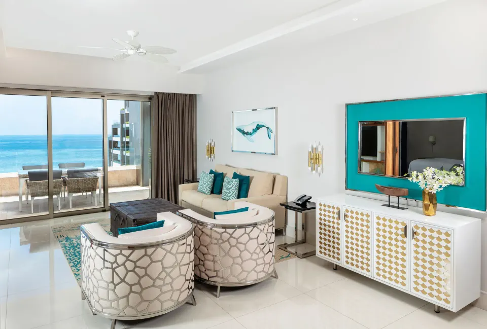1 Bedroom Ocean View living room with balcony seating and ocean view at Garza Blanca Los Cabos.