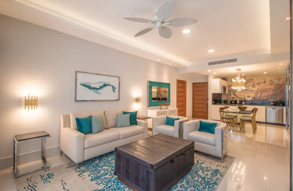 1 Bedroom Suite living room with sofa, chairs, dining area and kitchenette at Garza Blanca Los Cabos.