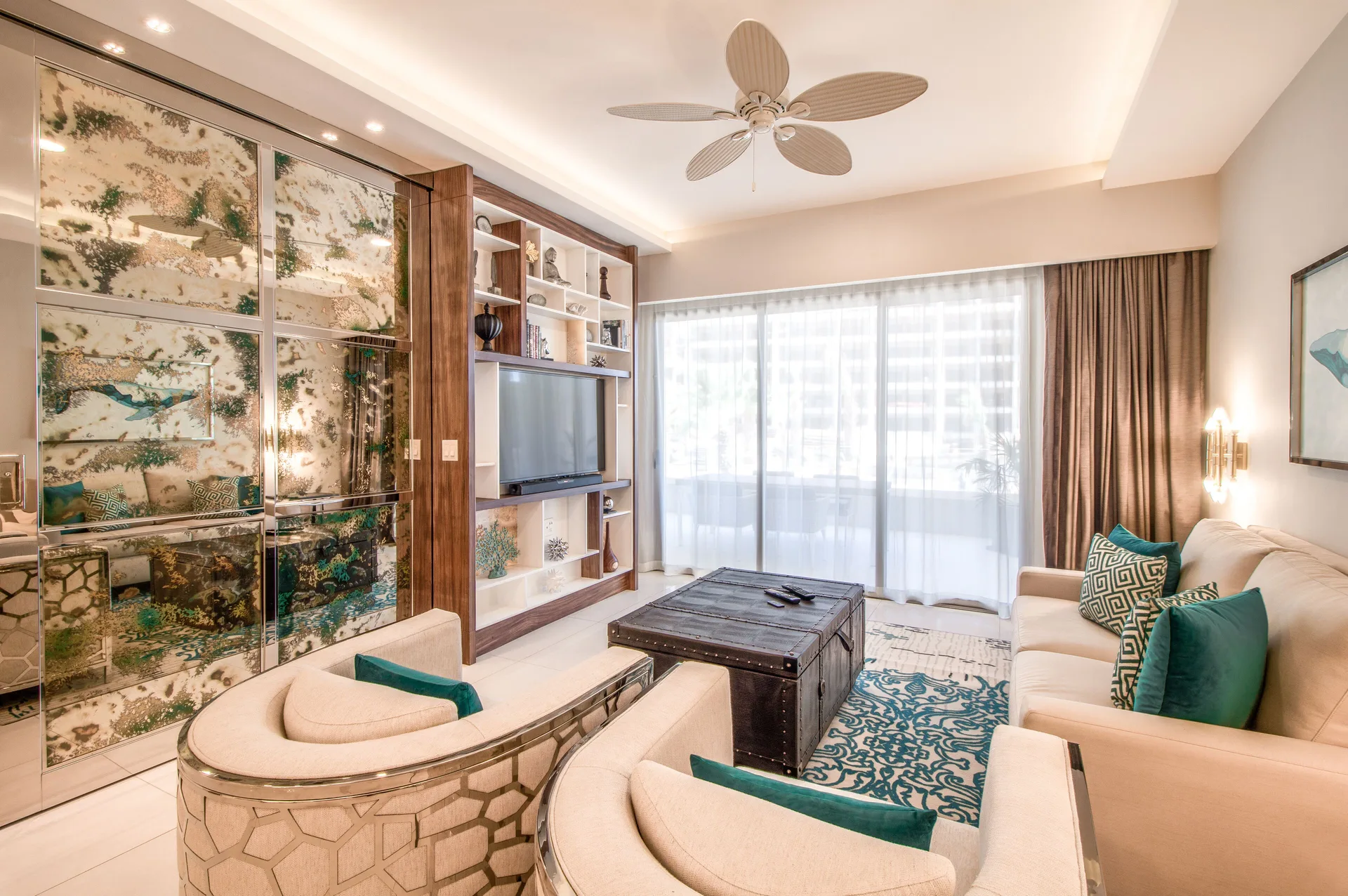 Living room of the 2 Bedroom Suite King at Garza Blanca Los Cabos with sofa seating and TV wall.