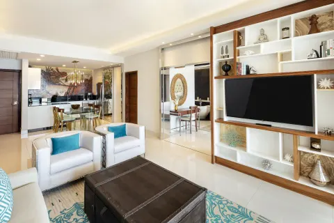 Open living and dining area in the 2 Bedroom Suite King at Garza Blanca Los Cabos with TV shelving.