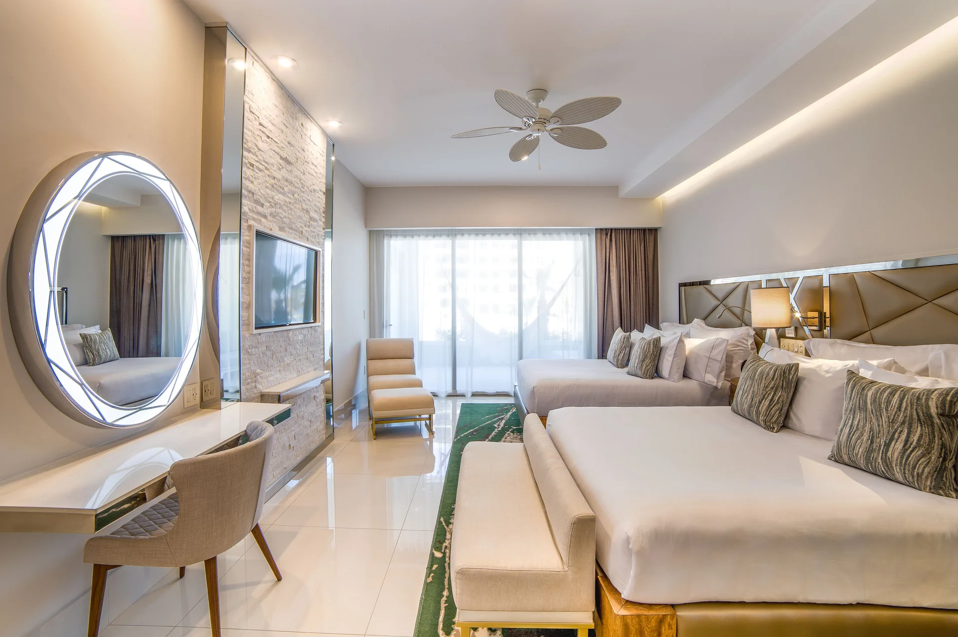 Second bedroom in the 2 Bedroom Suite King at Garza Blanca Los Cabos with two beds and vanity.