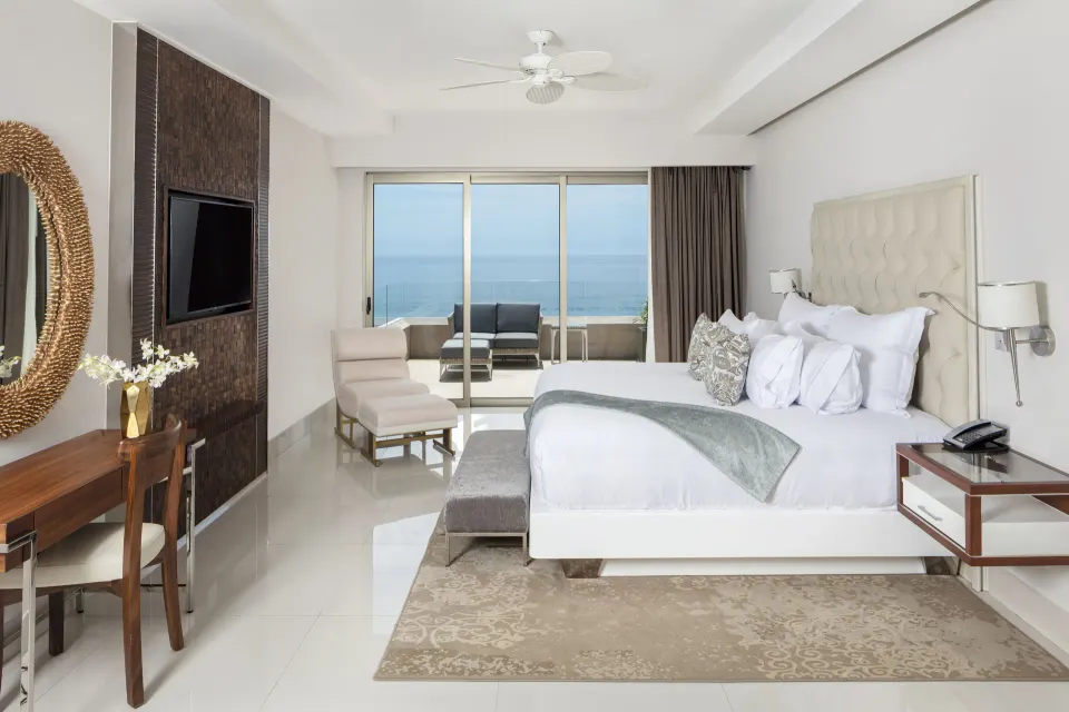4 Bedroom Loft Ocean View king bedroom at Garza Blanca Los Cabos with balcony doors and ocean beyond.