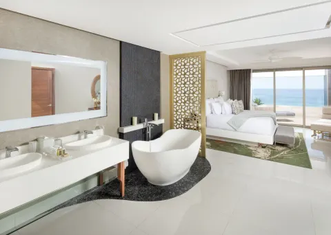4 Bedroom Loft Ocean View bedroom and bath at Garza Blanca Los Cabos with freestanding tub and ocean view.