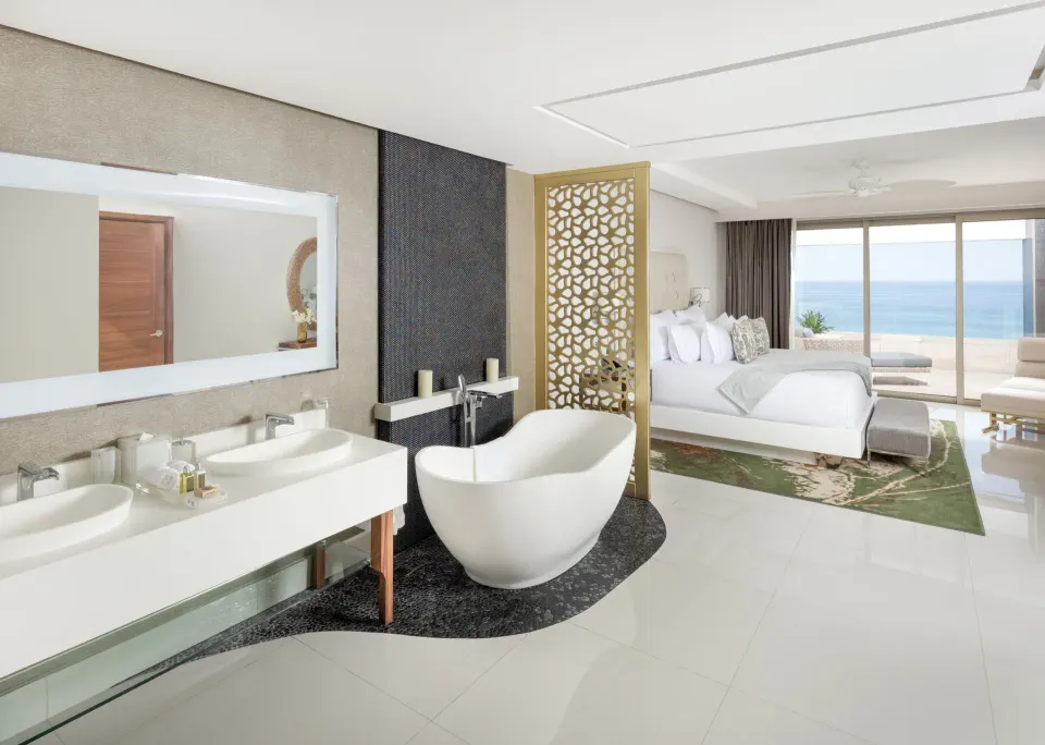 4 Bedroom Loft Ocean View bedroom and bath at Garza Blanca Los Cabos with freestanding tub and ocean view.