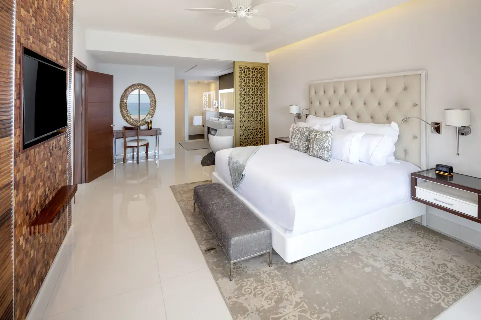 4 Bedroom Loft Ocean View king bedroom at Garza Blanca Los Cabos with vanity, TV, and open bath area.