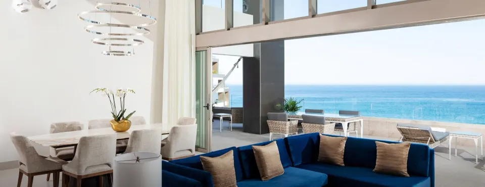 4 Bedroom Loft Ocean View living room at Garza Blanca Los Cabos opening to a furnished ocean-view terrace.