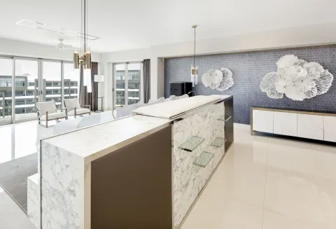 Penthouse interior with marble island and balcony windows at Garza Blanca Los Cabos.