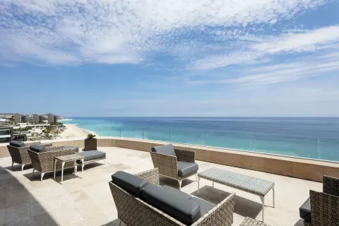 Penthouse oceanfront terrace seating overlooking the beach at Garza Blanca Los Cabos.