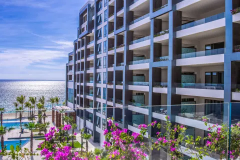 Junior Suite Ocean View balcony perspective of resort building and ocean at Garza Blanca Los Cabos.