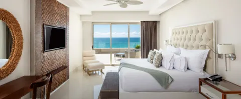 Junior Suite Ocean View king bed with balcony and ocean beyond at Garza Blanca Los Cabos.