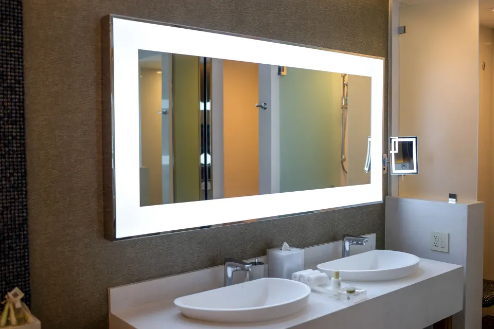 Junior Suite bathroom double vanity with lit mirror and vessel sinks at Garza Blanca Los Cabos.