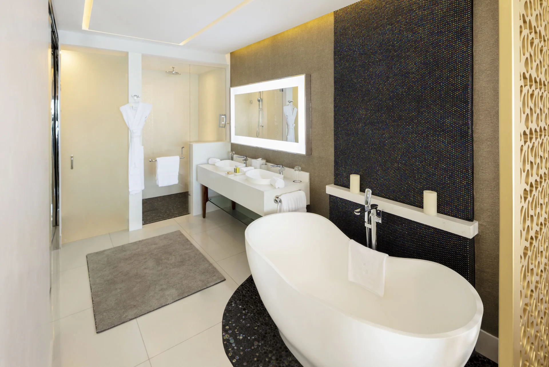 Junior Suite bathroom with freestanding tub, double vanity, and shower at Garza Blanca Los Cabos.