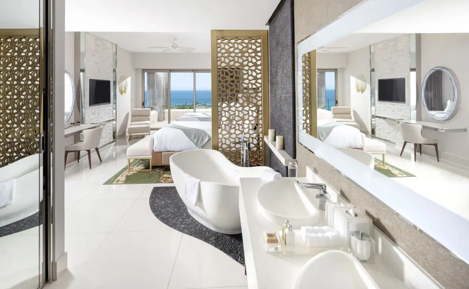 Loft Ocean View bath area with tub, vanities, and bedroom at Garza Blanca Los Cabos.
