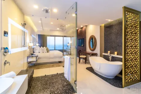 Loft Ocean View bathroom and bedroom with ocean beyond at Garza Blanca Los Cabos.