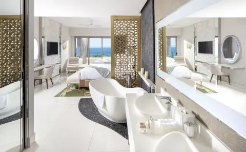 Loft Ocean View bathroom with freestanding tub and bedroom beyond at Garza Blanca Los Cabos.