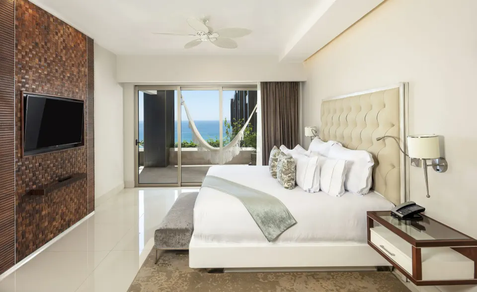 Loft Ocean View bedroom with king bed and terrace hammock at Garza Blanca Los Cabos.