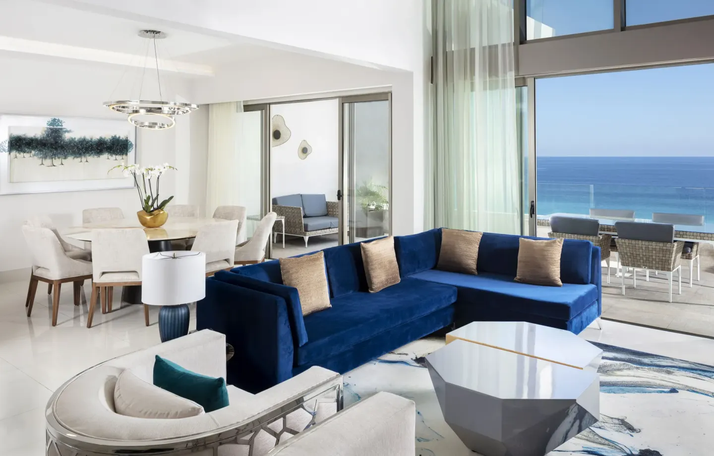 Loft Ocean View living room with blue sofa and balcony at Garza Blanca Los Cabos.