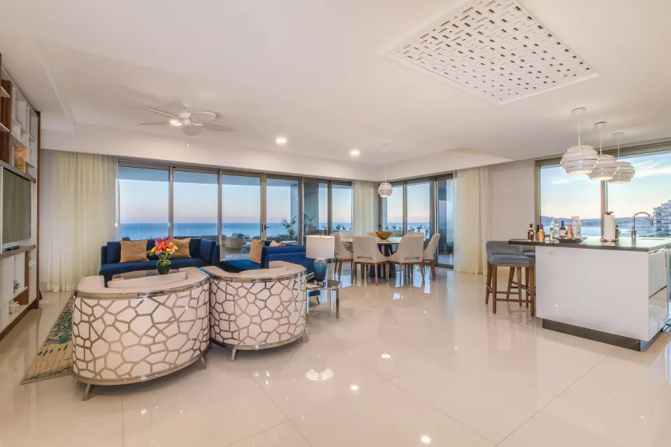 Open living, dining and kitchen area in an ocean-view suite at Garza Blanca Los Cabos.