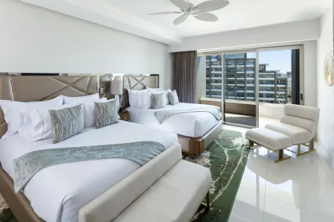 Two-bed guest room with balcony in a 3 Bedroom Suite at Garza Blanca Los Cabos.
