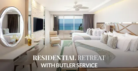 Two-bed ocean-view bedroom with promotional text at Garza Blanca Los Cabos.