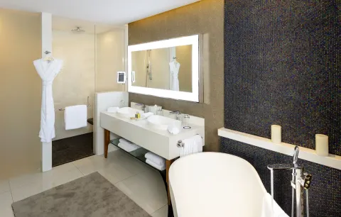 Bathroom with double vanity and freestanding tub at Garza Blanca Los Cabos.