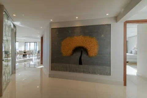 Suite hallway with large tree artwork at Garza Blanca Los Cabos.