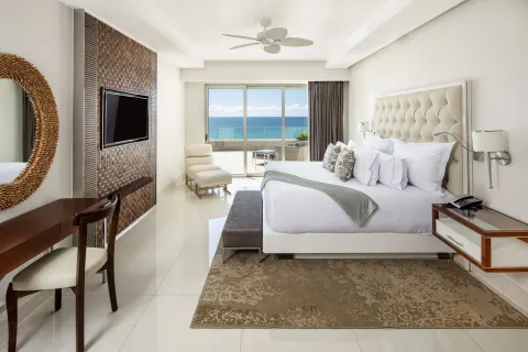 King bedroom with ocean-facing balcony in a 3 Bedroom Suite at Garza Blanca Los Cabos.