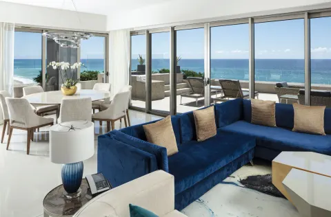 Ocean-view living and dining area in a 3 Bedroom Suite at Garza Blanca Los Cabos.