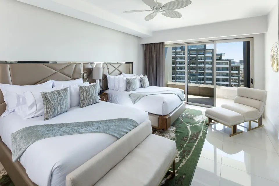 Two-bed bedroom with balcony in a 3 Bedroom Suite at Garza Blanca Los Cabos.