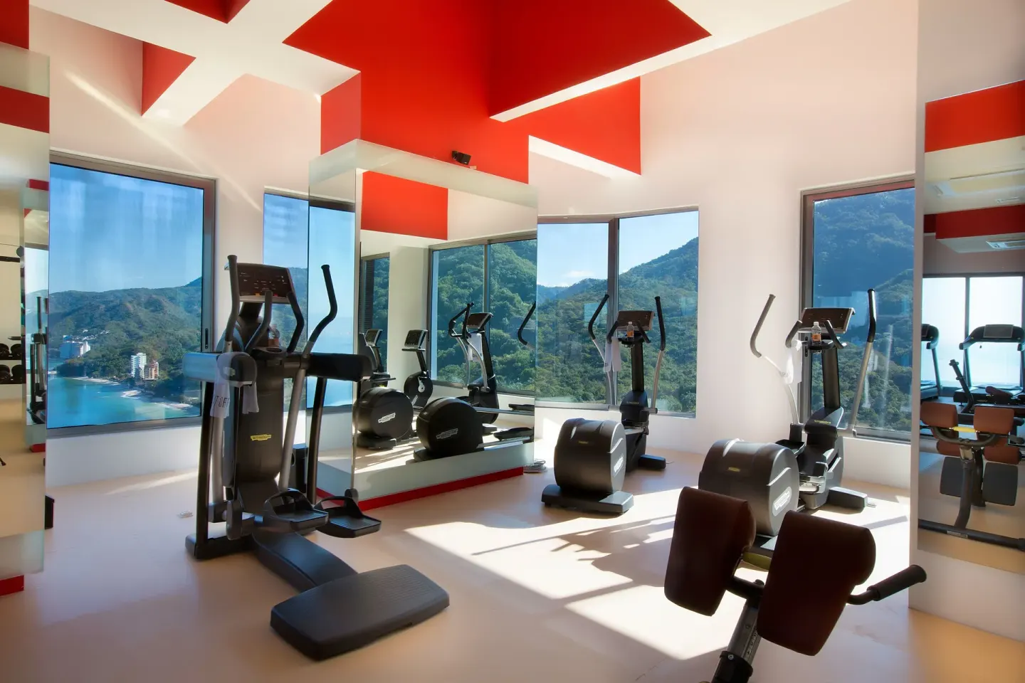 Fitness room with cardio machines and mountain views at Garza Blanca Preserve Resort & Spa.