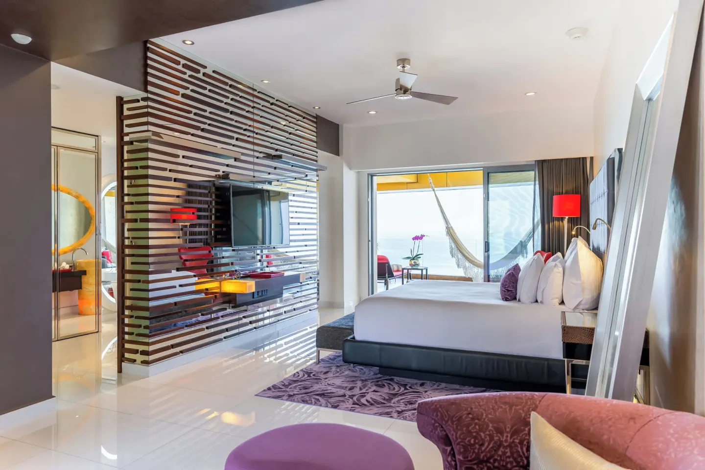 Modern king bed suite with balcony hammock at Garza Blanca Preserve Resort & Spa.