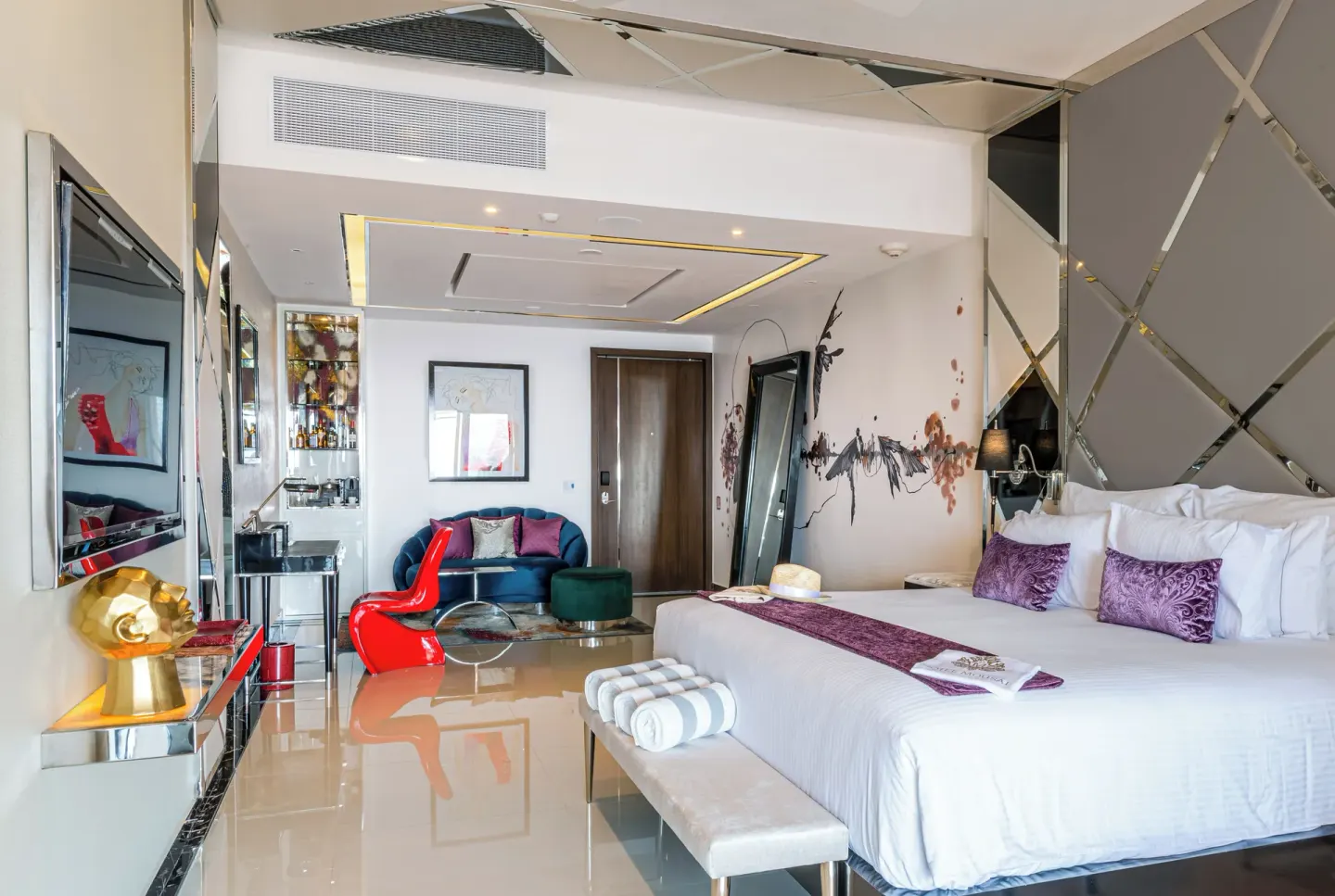 Stylish king bed guest room with seating area at Garza Blanca Preserve Resort & Spa.