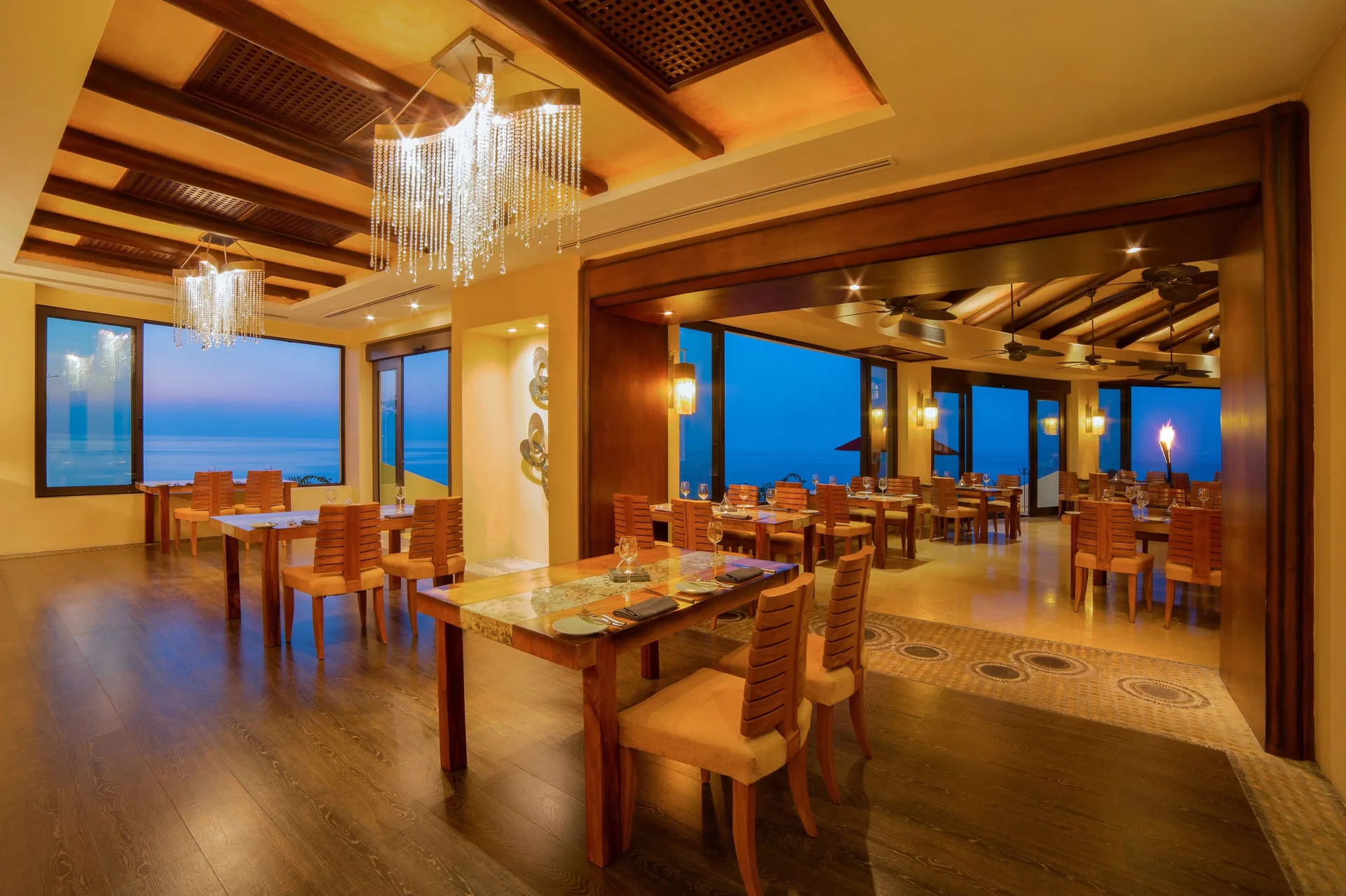 Warm wood dining room with ocean views at Garza Blanca Preserve Resort & Spa.