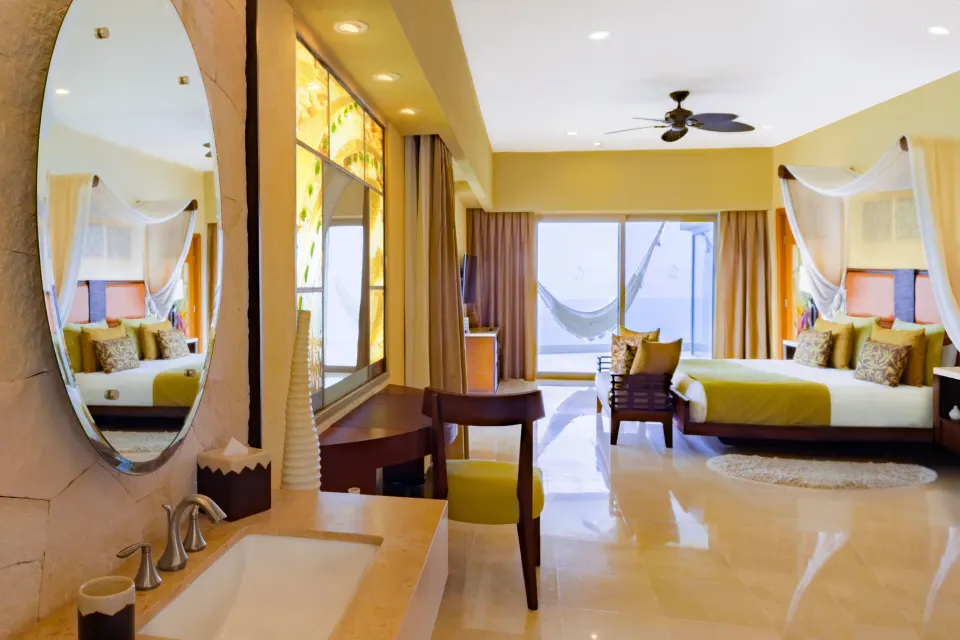 King bedroom with vanity in a 2 Bedroom Suite Panoramic at Garza Blanca Preserve Resort & Spa.