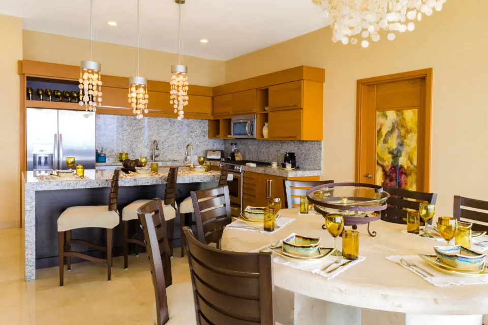 Kitchen and dining table in a 2 Bedroom Suite Panoramic at Garza Blanca Preserve Resort & Spa.