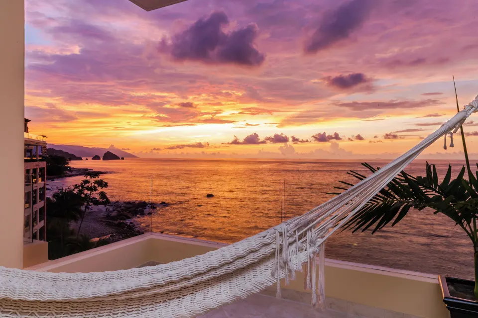 Balcony hammock overlooking the ocean at sunset at Garza Blanca Preserve Resort & Spa.