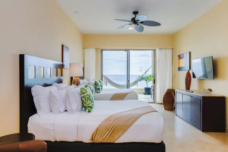Deluxe room with two beds and balcony hammock at Garza Blanca Preserve Resort & Spa.