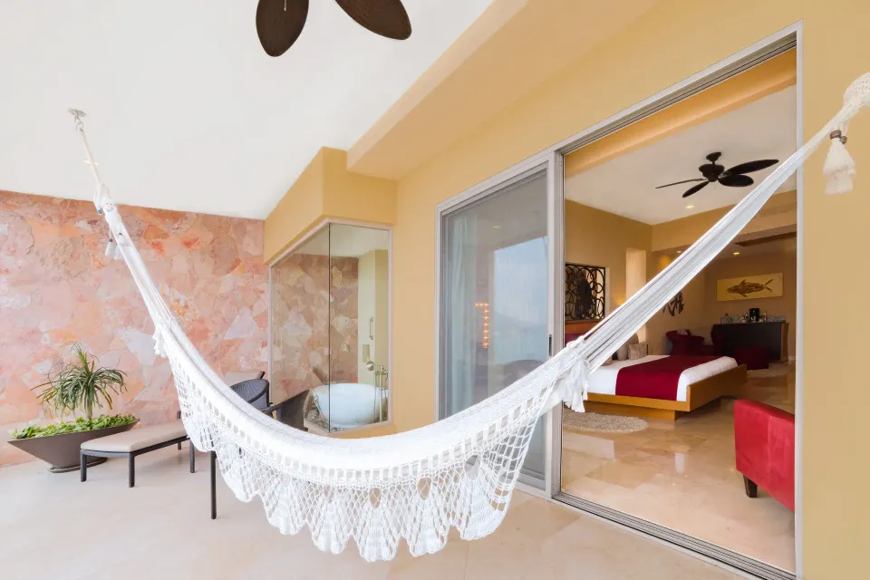 Junior Panoramic Suite balcony hammock outside the king bed at Garza Blanca Preserve Resort & Spa.