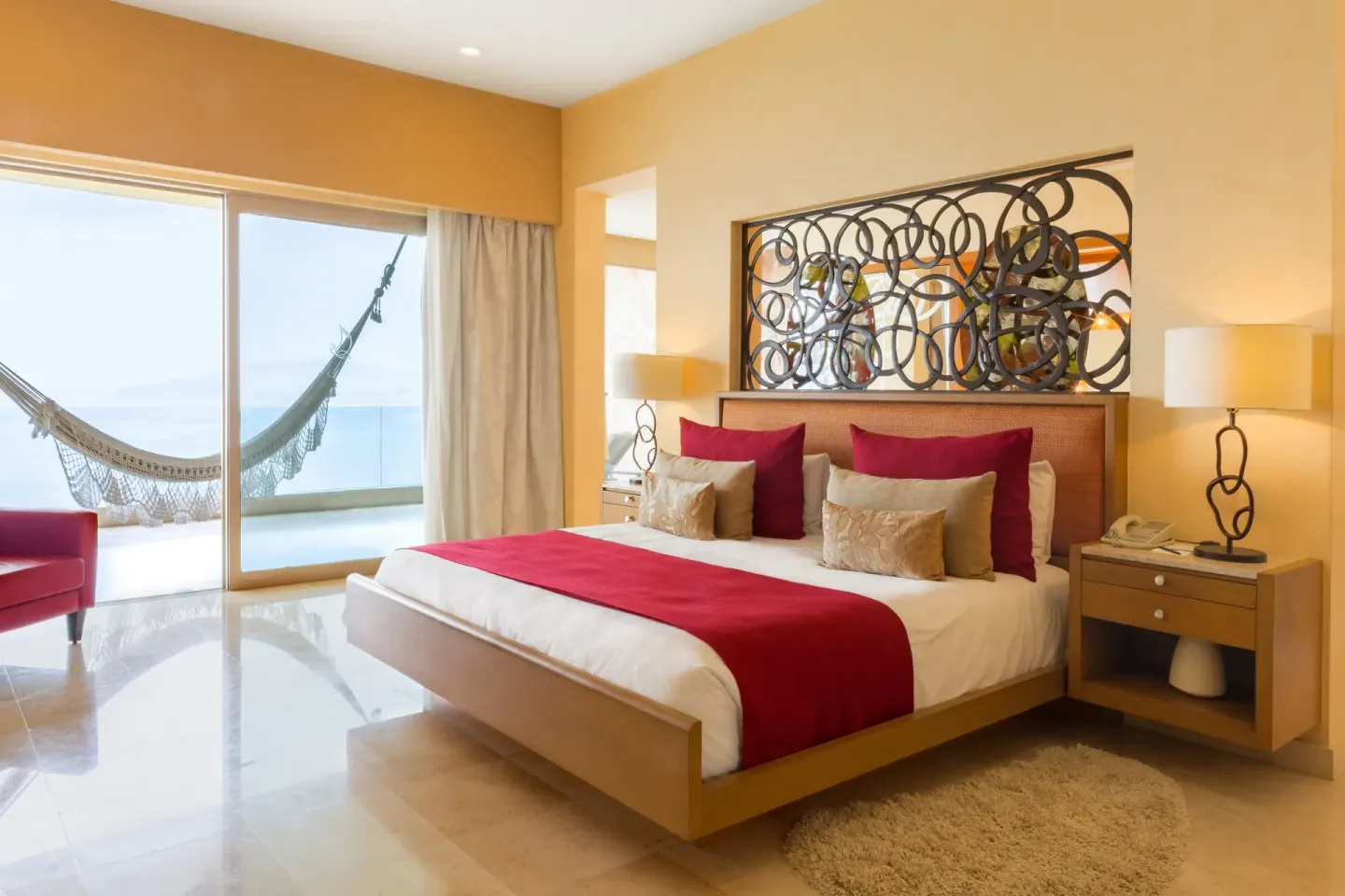 Junior Panoramic Suite king bed and balcony hammock at Garza Blanca Preserve Resort & Spa.