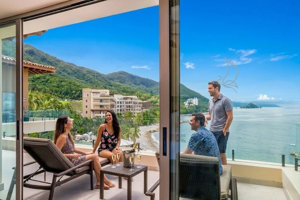 Oceanfront Penthouse balcony seating with guests and ocean view at Garza Blanca Preserve Resort & Spa.