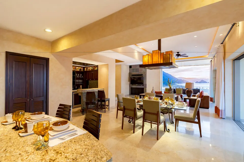 Oceanfront Penthouse dining room at Garza Blanca Preserve Resort & Spa with kitchen counter and bay view.