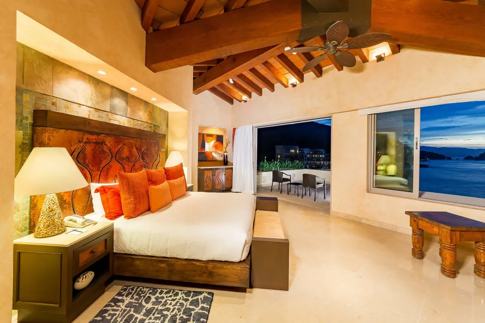 Oceanfront Penthouse king bedroom at Garza Blanca Preserve Resort & Spa with vaulted ceiling and ocean windows.