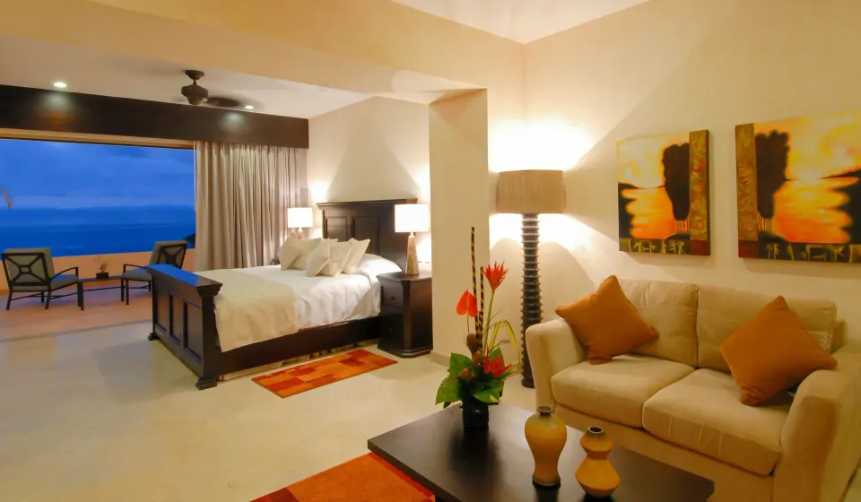 Oceanfront Penthouse bedroom and sitting area at Garza Blanca Preserve Resort & Spa with balcony sea view.