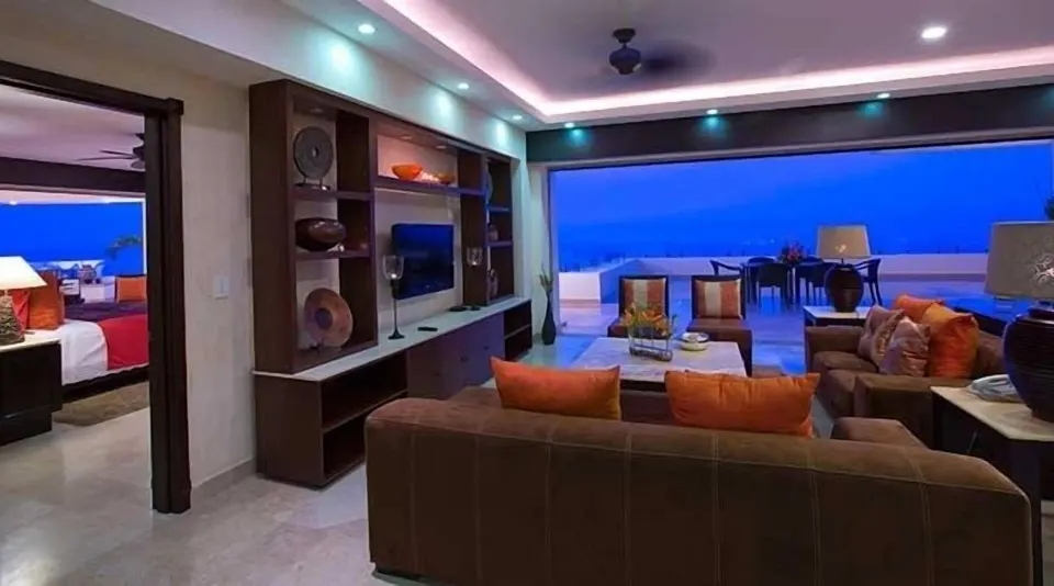 Oceanfront Penthouse living room at Garza Blanca Preserve Resort & Spa with sofas and terrace view.