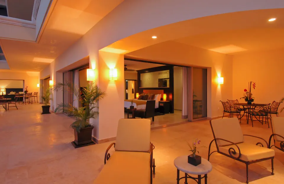 Oceanfront Penthouse terrace at Garza Blanca Preserve Resort & Spa with loungers and bedroom access at dusk.